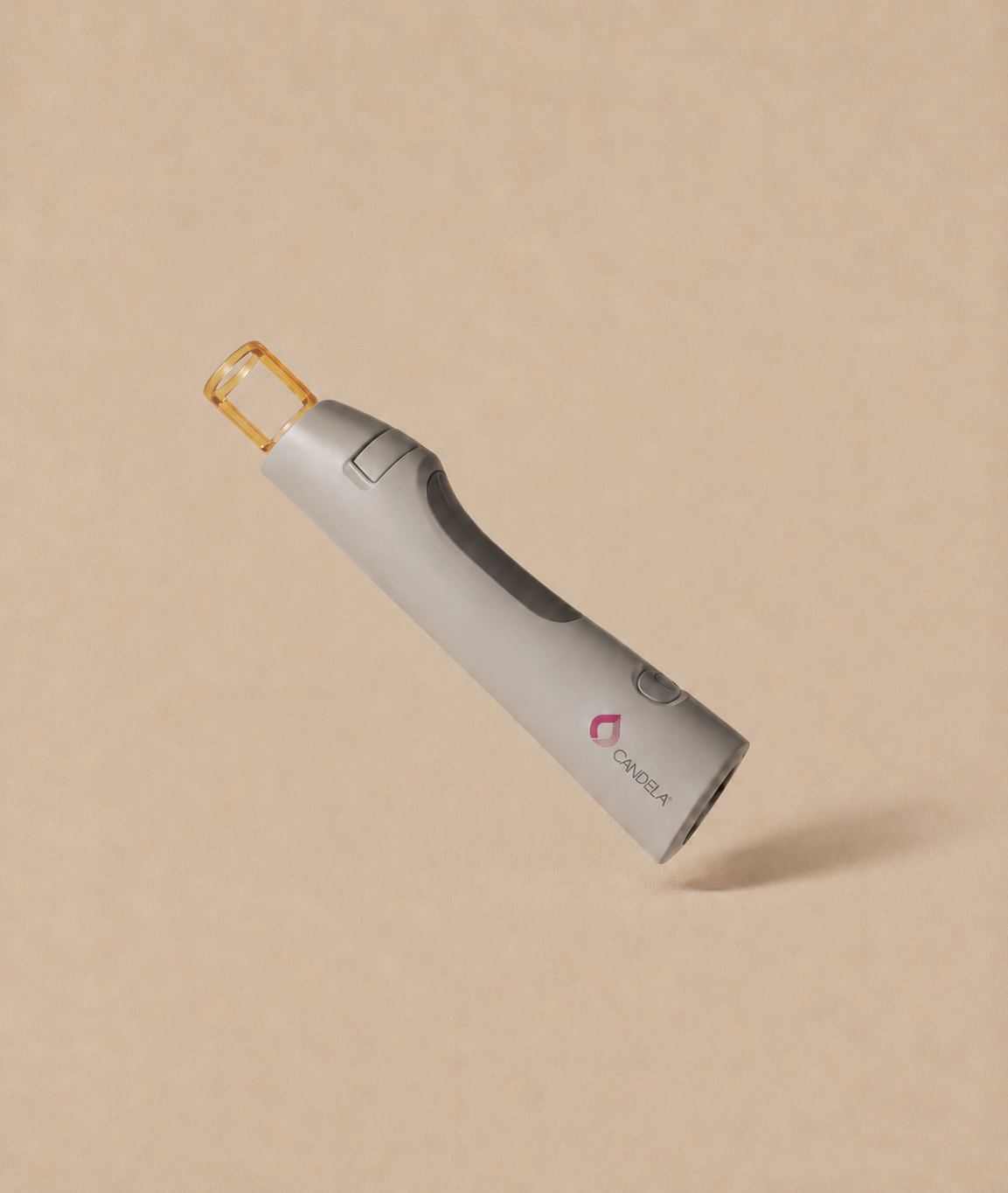 Candela YAG laser facial handpiece on a beige background
